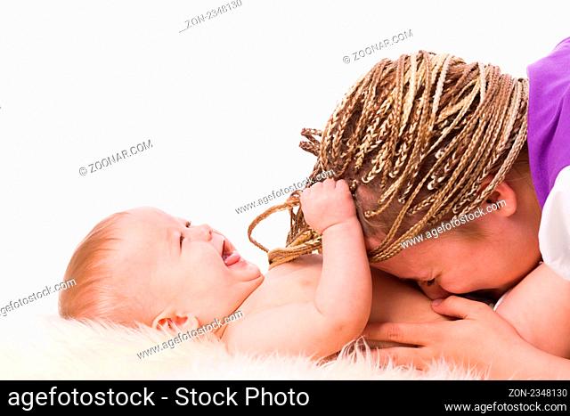 Mother playing with baby both laughing isolated on white