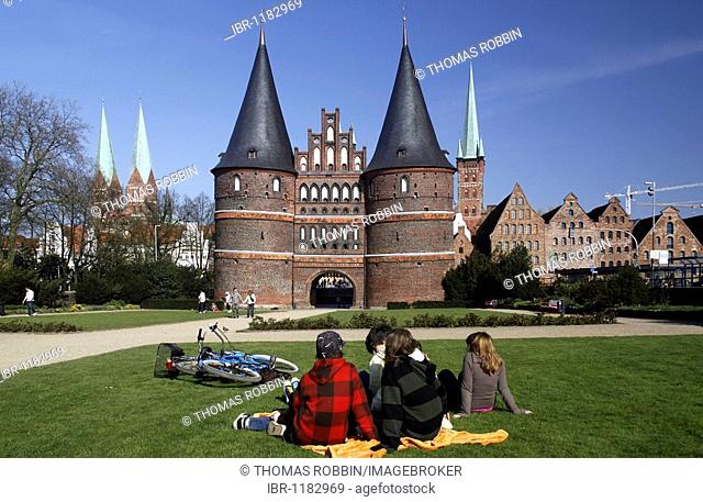 Adolescents in front of the Holstentor city gate, Hanseatic City of Luebeck, Schleswig-Holstein, Germany, Europe