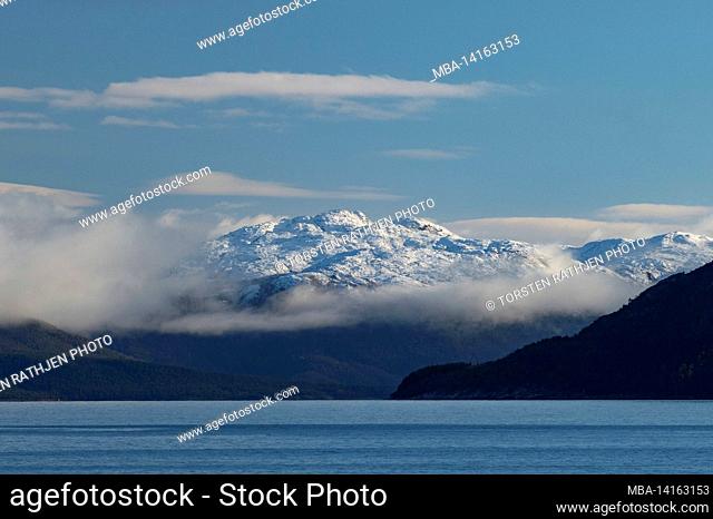 clouds and snow-capped mountains at the north sea, holm, nordland, norway