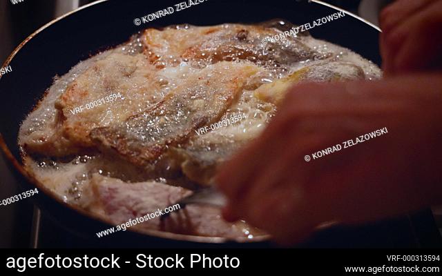 Preparation of traditional Polish dish for Christmas Eve Supper, fried carp fish, 4k video