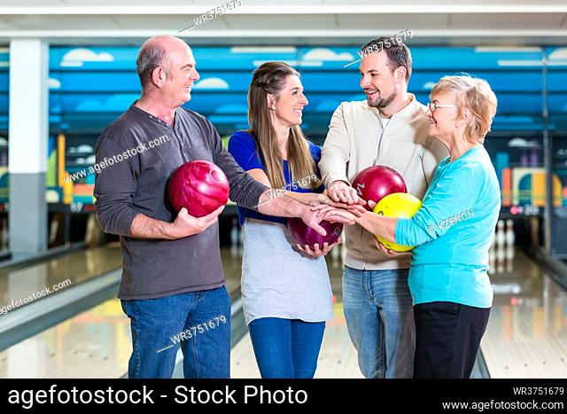 Portrait of smiling family stacking their hands