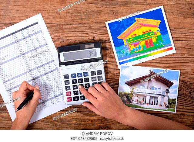 Close-up Of A Person Calculating The Heat Loss And Energy Efficiency Of A House
