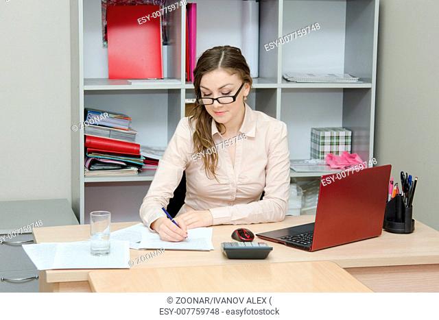 Office worker signs the document