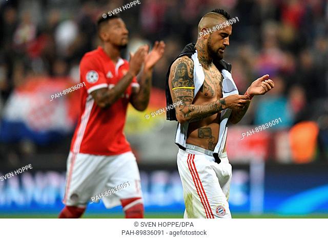 Munich's Arturo Vidal (r) and Jerome Boateng react after the first leg of the Champions League quarter final match between Bayern Munich and Real Madrid in the...