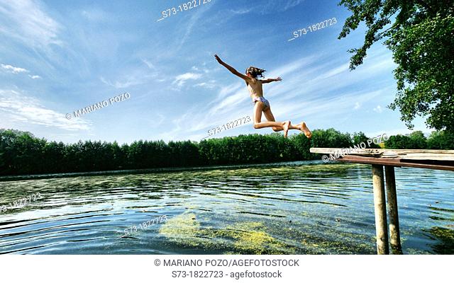 Girl jumping to the Lake Avral, Kirillovka, Samara Region, Russian Federation