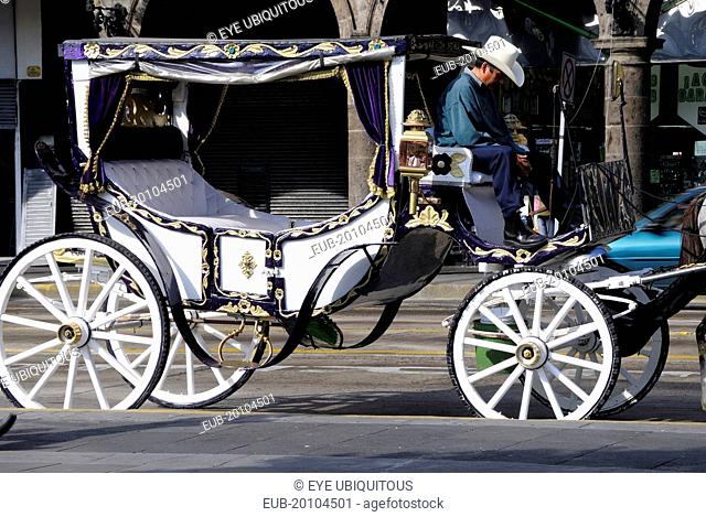Horse drawn carriage or calandrias and driver in the Plaza de Armas