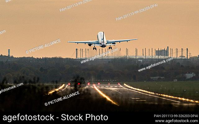 13 November 2020, Hamburg: An Airbus of the airline Eurowings takes off from Hamburg Airport. In the background you can see the Volksparkstadion