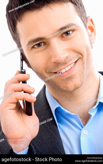 Closeup portrait of casual businessman talking on mobile phone. Isolated on white