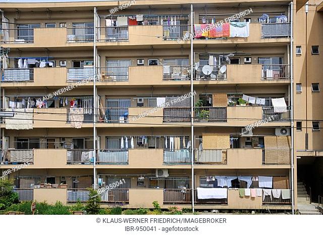 Typical use of balconies as roofed clothes dryers, storage space, with satellite dish, Iwakura near Kyoto, Japan, Asia