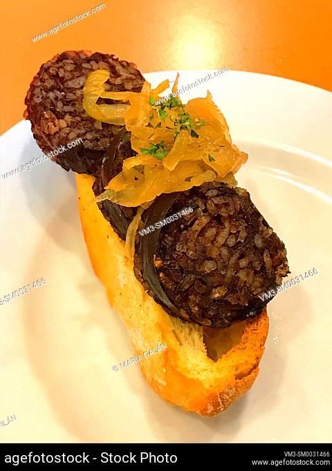 Spanish tapa: black pudding with onion on bread. Spain