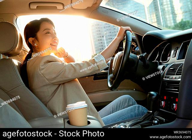 The fashionable young woman driving