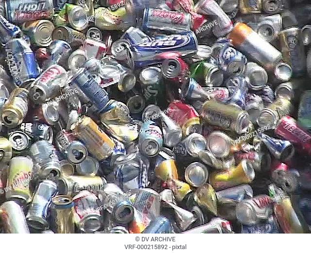 Aluminum cans move down a conveyor belt in a recycling center