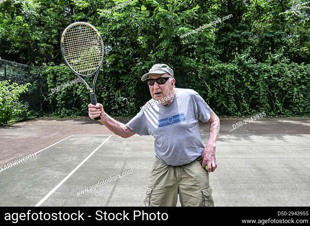 Washington DC USA Older man playing tennis, retired, exercise
