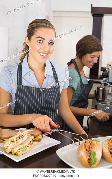Pretty waitresses working with a smile at the coffee shop