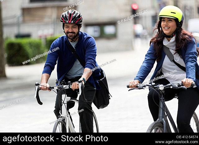 Business people riding bicycles on street