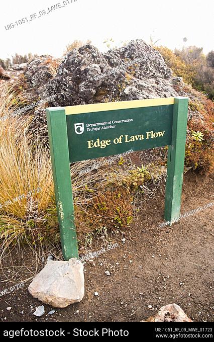 Edge of Lava Flow Sign in Tongariro National Park, North Island, New Zealand. The Tongariro National Park is located in the centre of North Island of New...
