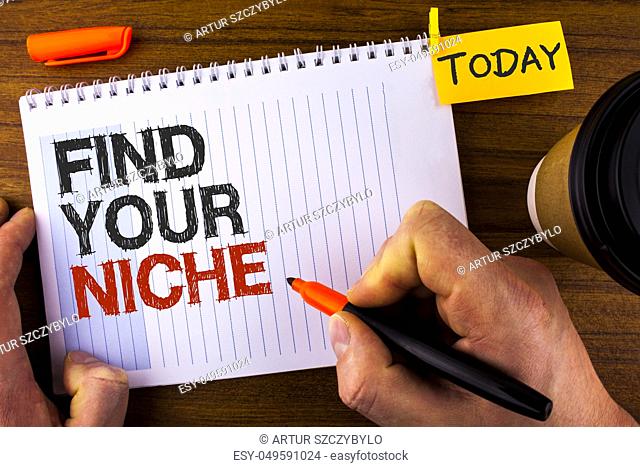 Text sign showing Find Your Niche. Conceptual photo search for your field Decide Choice education Work written by Man Notepad holding Marker Wooden background...