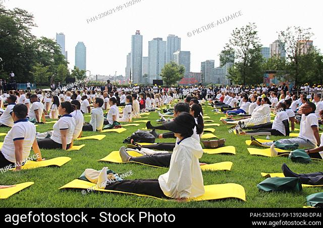21 June 2023, USA, New York: Hundreds of people practice yoga in front of the United Nations. To mark World Yoga Day, India's Prime Minister Modi took part in a...