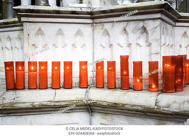 Red candles lit inside church, religion