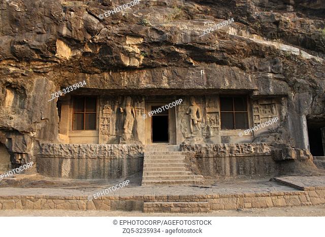 Outside view of Cave 2, doorway is flanked by huge Bodhisattvas with converging dwarfs above, Buddhist Caves, Ellora, Aurangabad, Maharashtra