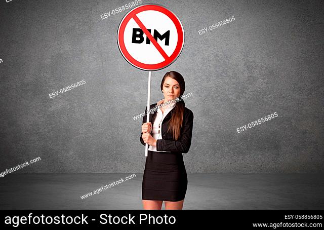 Young business person holdig traffic sign with BIM abbreviation, technology solution concept