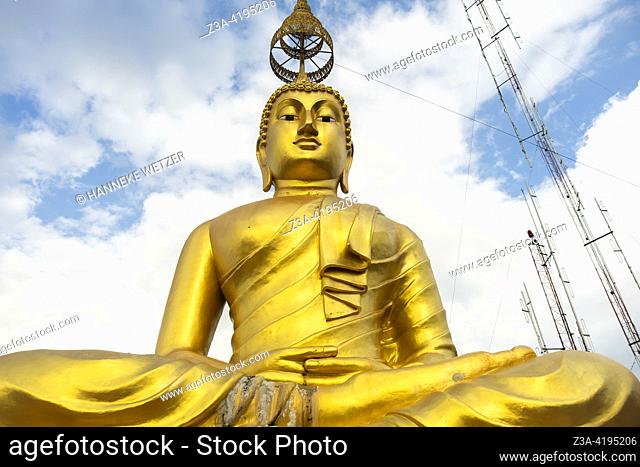 Huge golden Buddha at the sacred site of the Tiger Cave Temple (Wat Tham Sua) in Krabi, Thailand