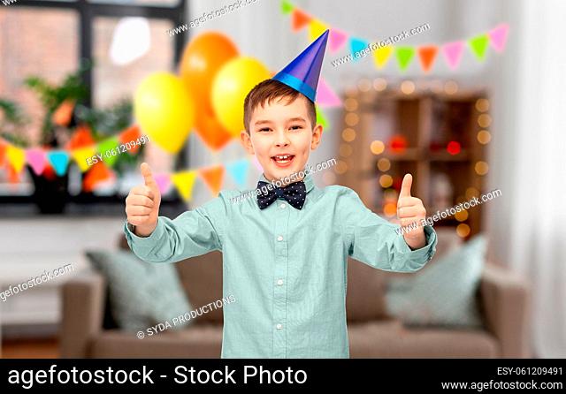boy showing thumbs up at birthday party at home