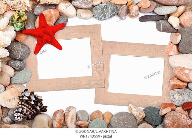 Paper Vintage photo frame with red starfish and pebbles