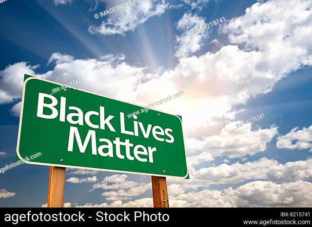 Black lives matter green road sign with dramatic clouds and sky