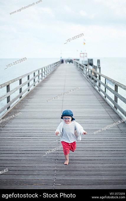 2 years old boy in a dock at the beach