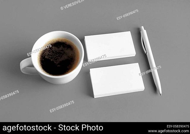 Corporate stationery template. Blank business cards, coffee cup and pen on gray background