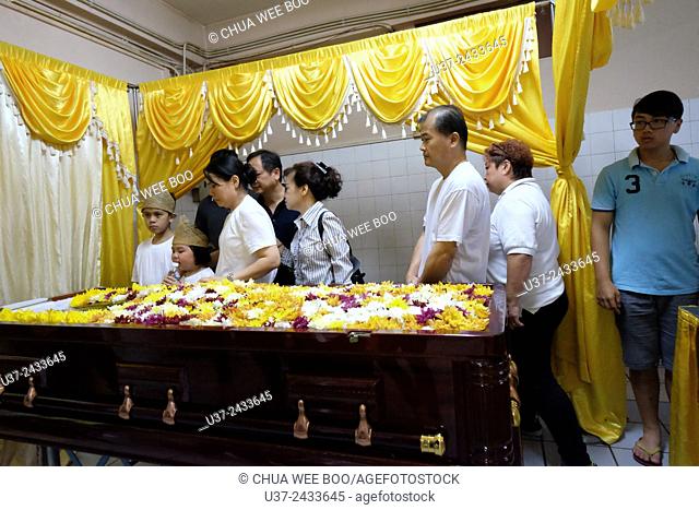 Best friends paying their last respect. Sarawakian chinese funeral ceremony. Malaysia
