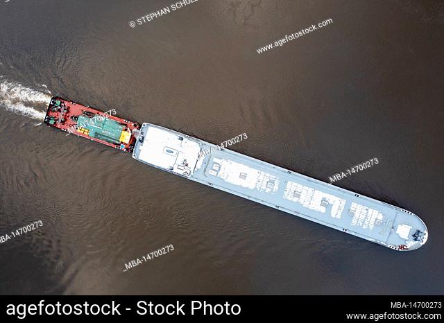 Pusher vessel TR 15 pushes hull of newly built tanker up the river Elbe, Magdeburg, Saxony-Anhalt, Germany