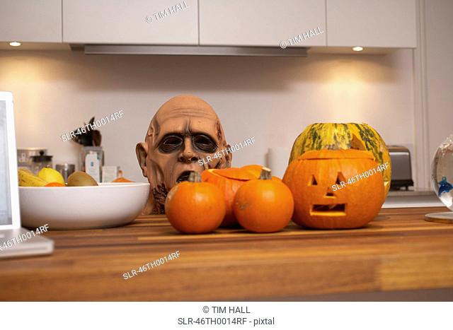 Jack-o-lanterns and mask in kitchen