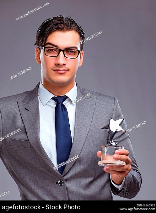 The businessman holding star award in business concept