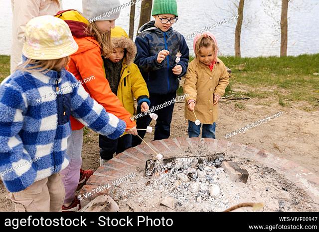 Children roasting marshmallows on fire