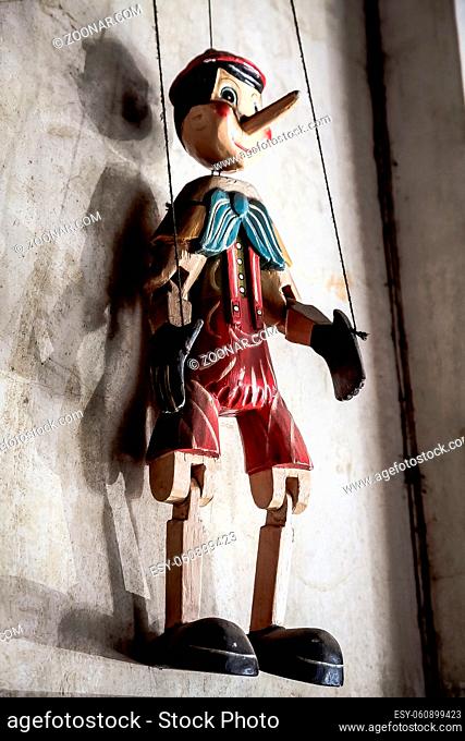 Selective Focus Abstract image of a Wooden String Puppet Boy hanging on a wall