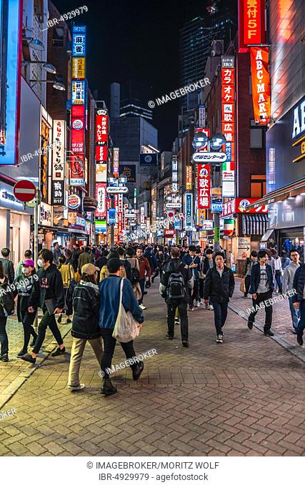 Very busy pedestrian zone with many shopping centers and shops, illuminated with a lot of illuminated advertising at night, Shibuya, Udagawacho, Tokyo, Japan