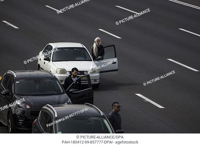 People exit their cars on a highway and observe two minutes of silence to mark the Yom HaShoah (Holocaust and Heroism Remembrance Day)