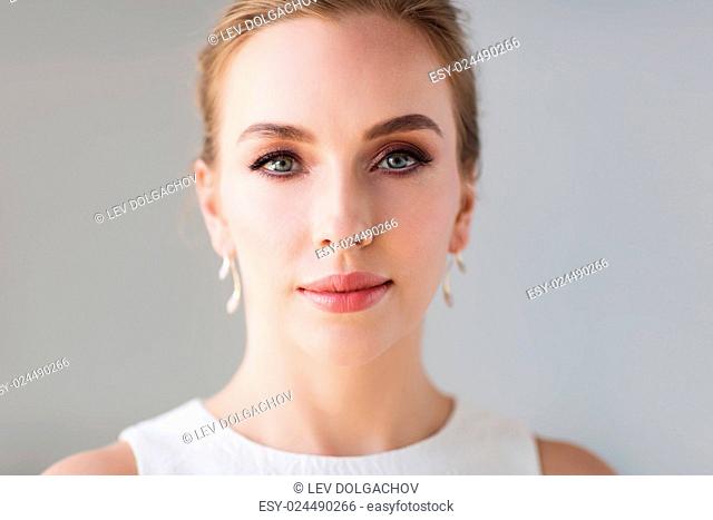 beauty, wedding and people concept - face of beautiful woman or bride in white dress