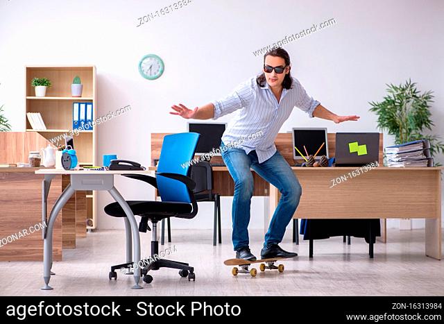 Young employee with skateboard in the office