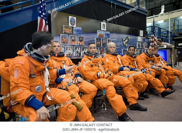 Attired in training versions of their shuttle launch and entry suits, the STS-119 crewmembers await the start of a training session in the Space Vehicle Mockup...