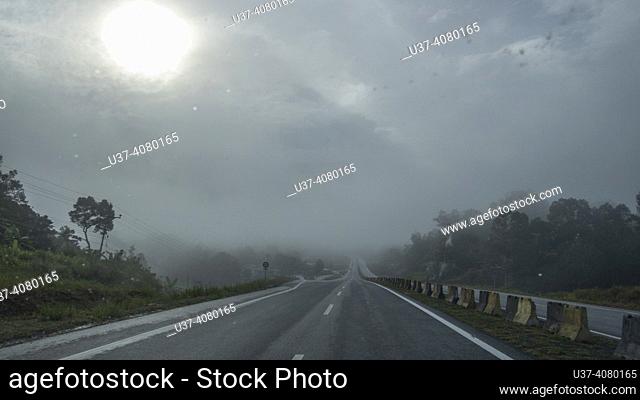 A misty morning along Serian-Simanggang road, Sarawak, East Malaysia, Borneo, The Serian-Simanggang road in Sarawak, East Malaysia is an important thoroughfare...
