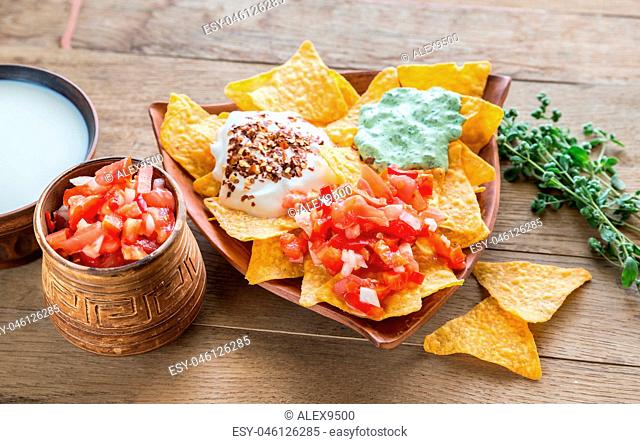 Cheese nachos with different types of sauce