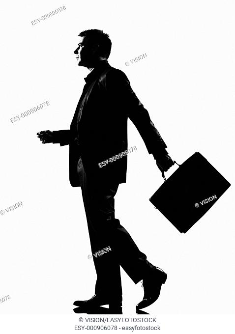 silhouette caucasian business man walking profile with briefcase full length on studio isolated white background