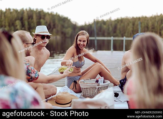 Friends having picnic at lake