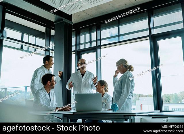 Doctors and scientist having discussion while standing at office