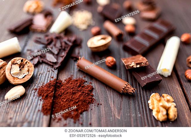 Variety of delicious chocolate on wooden background
