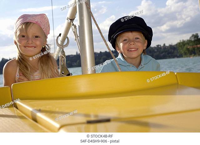 Little boy and girl a plastic boat
