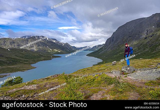Lake Gjende, hiker on the Besseggen hike, Jotunheimen National Park, Vågå, Innlandet, Norway, Europe